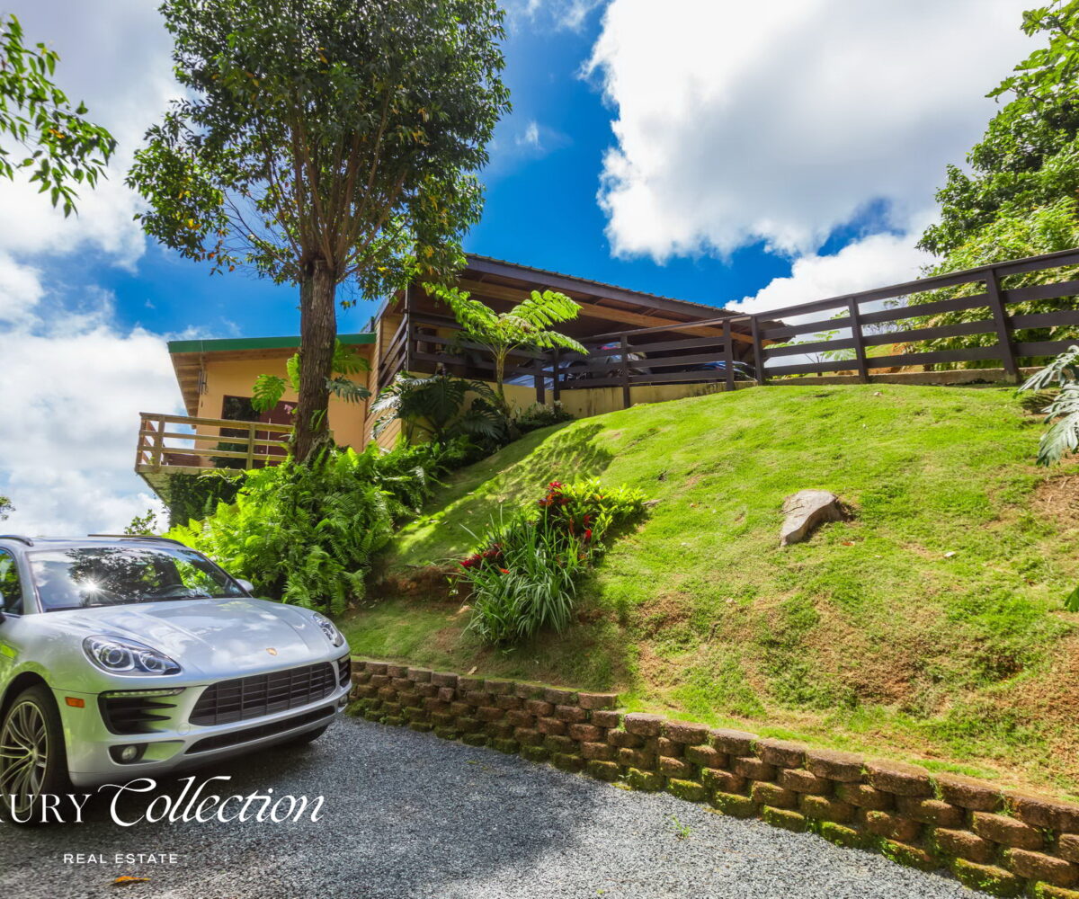 1.5 acres two-story country house in the mountains of Cayey Puerto Rico for sale with 3 bedrooms and 3.5 bathrooms. Lake and mountain views. Luxury Collection Real Estate