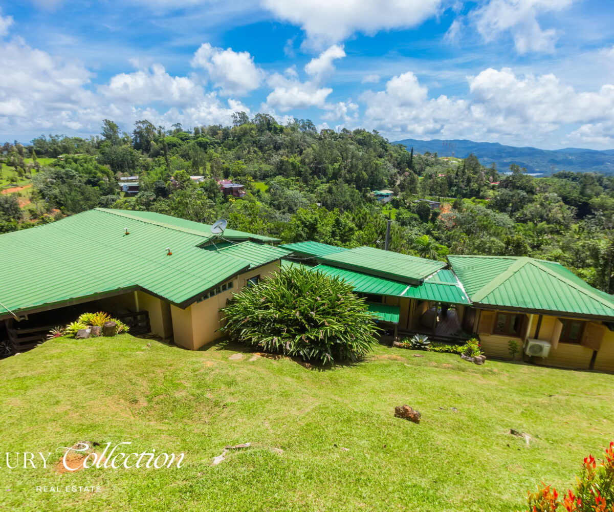 1.5 acres two-story country house in the mountains of Cayey Puerto Rico for sale with 3 bedrooms and 3.5 bathrooms. Lake and mountain views. Luxury Collection Real Estate