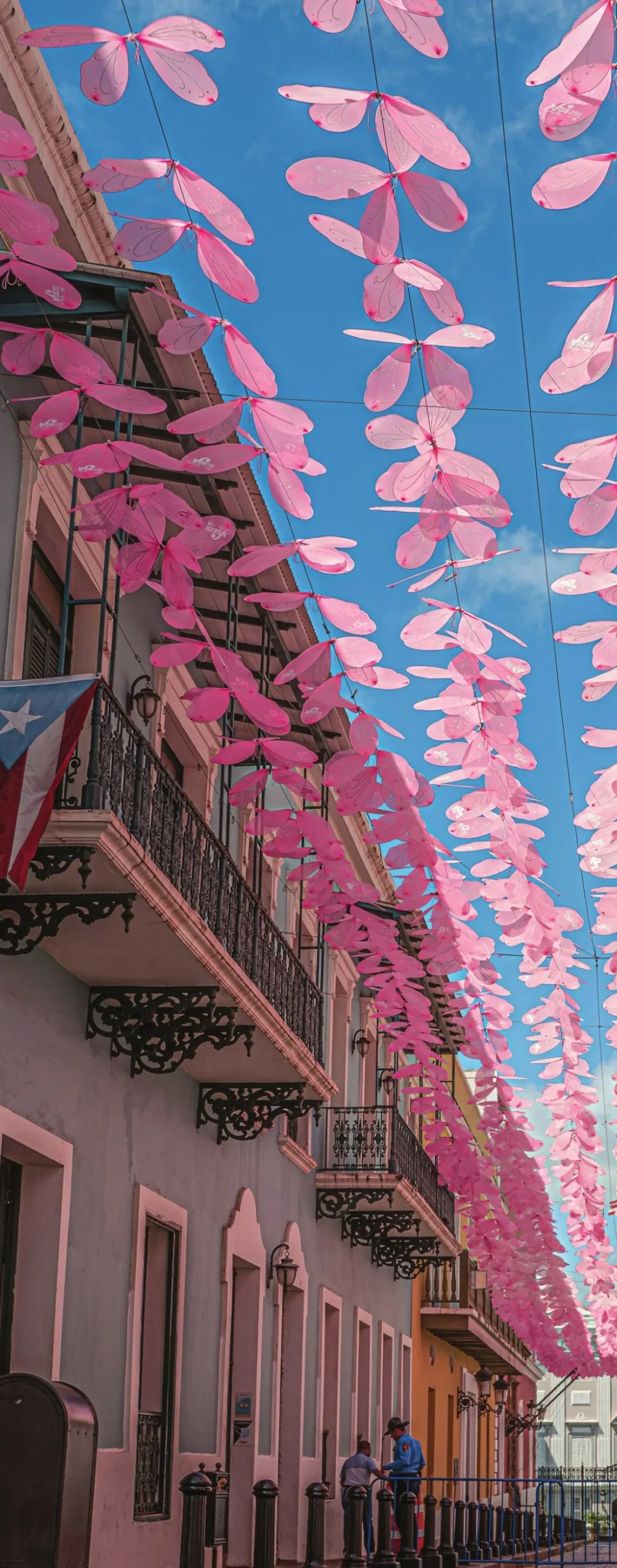 Colorful street with pink decorations and colonial balconies in Old San Juan, Puerto Rico