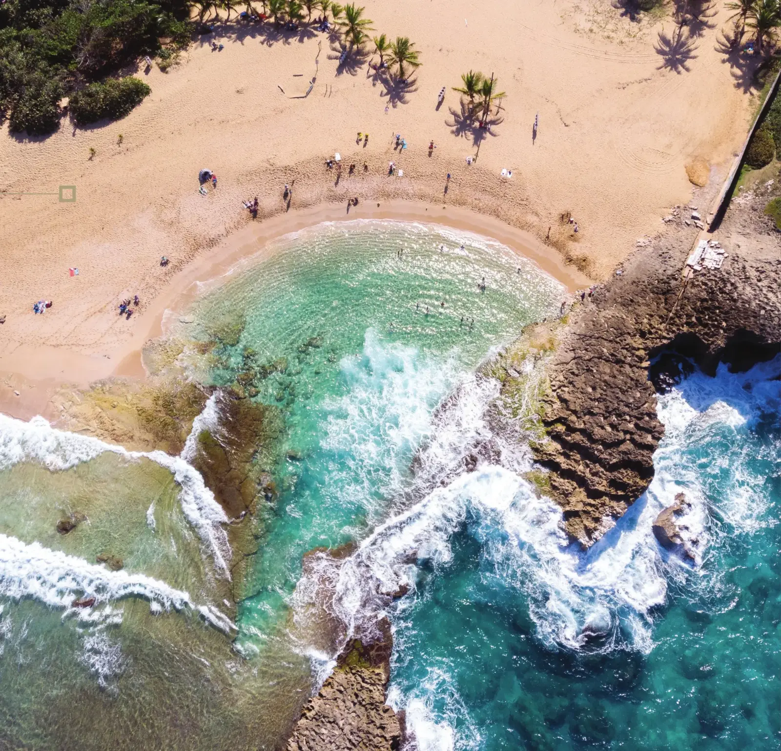 Aerial view of a crescent beach and turquoise water on the north coast of Puerto Rico